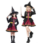 Girl wearing a black and burgundy witch costume with a pointed hat and striped tie
