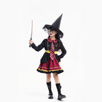 Girl wearing a black and burgundy witch costume with a pointed hat and striped tie - view 3