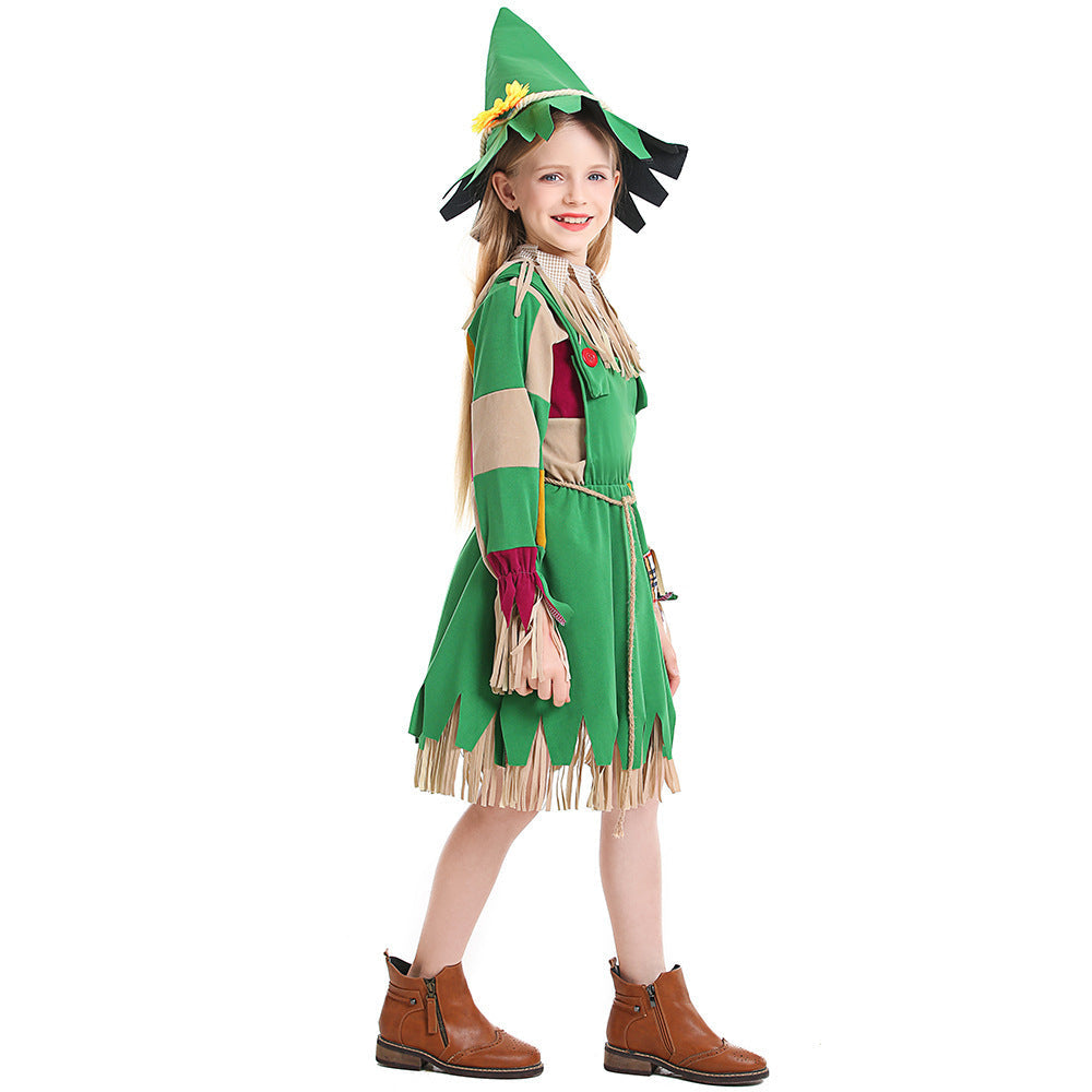 Girl wearing a green scarecrow Halloween costume with patchwork sleeves, fringe trim, rope belt and sunflower hat - view 4