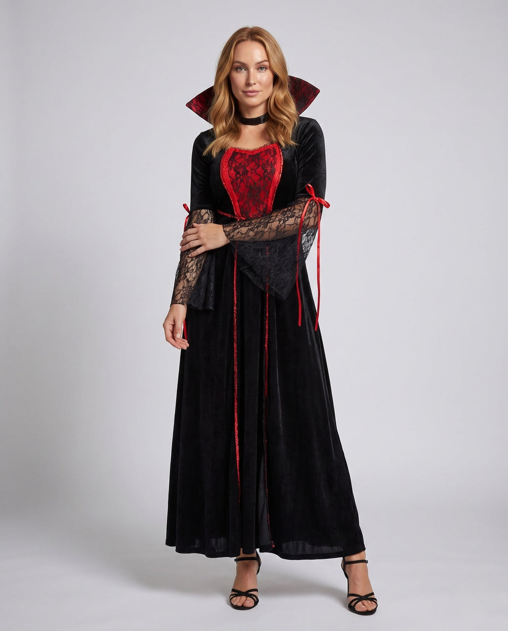 Women's black velvet vampire costume dress with red lace front panel, high collar and lace bell sleeves