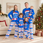 Family wearing blue Christmas pajamas with Santa hat graphic and snowflake print pants