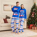 Family wearing blue Christmas pajamas with Santa hat graphic and snowflake print pants - view 2