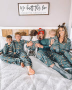 Family wearing matching green safari print Christmas pajamas