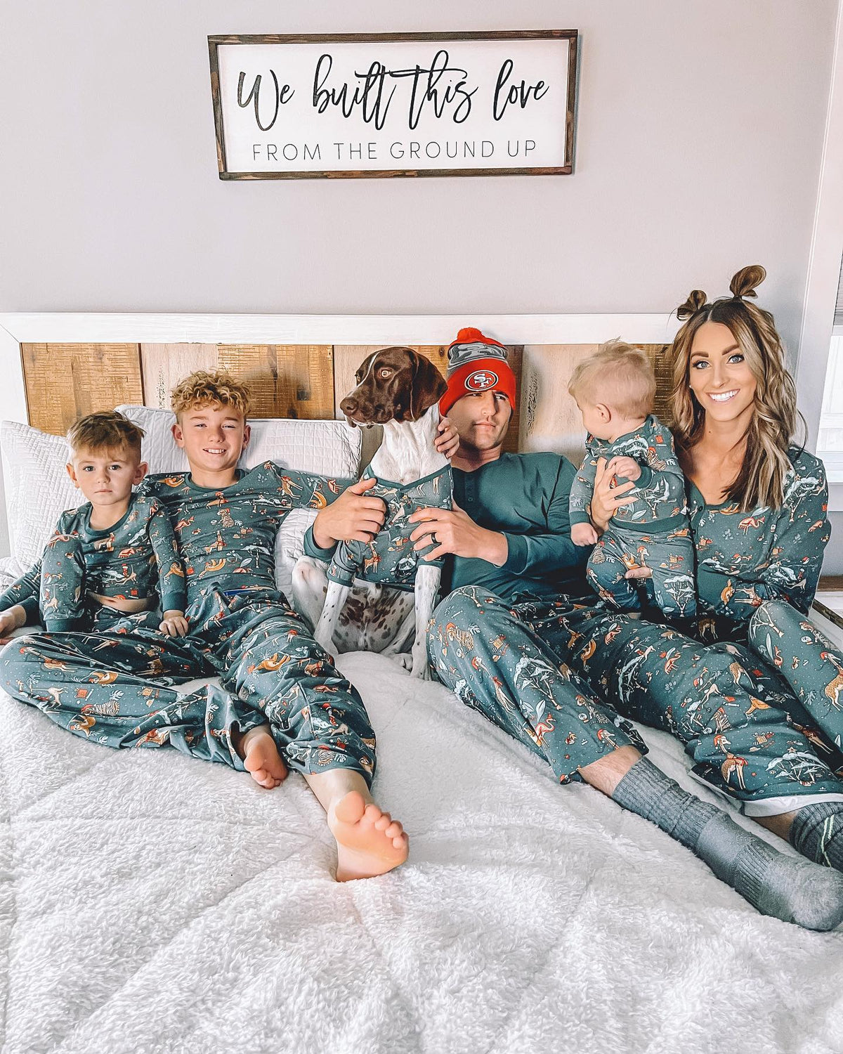 Family wearing matching green safari print Christmas pajamas