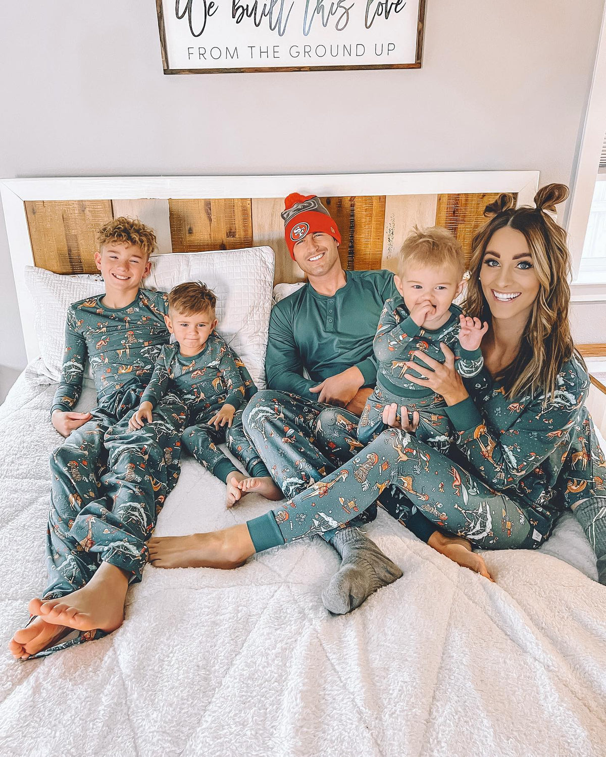 Family wearing matching green safari print Christmas pajamas - view 16
