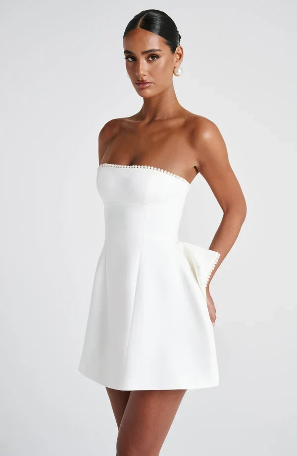 Strapless mini dress with pearl-trim neckline and oversized cascading back bow - view 12