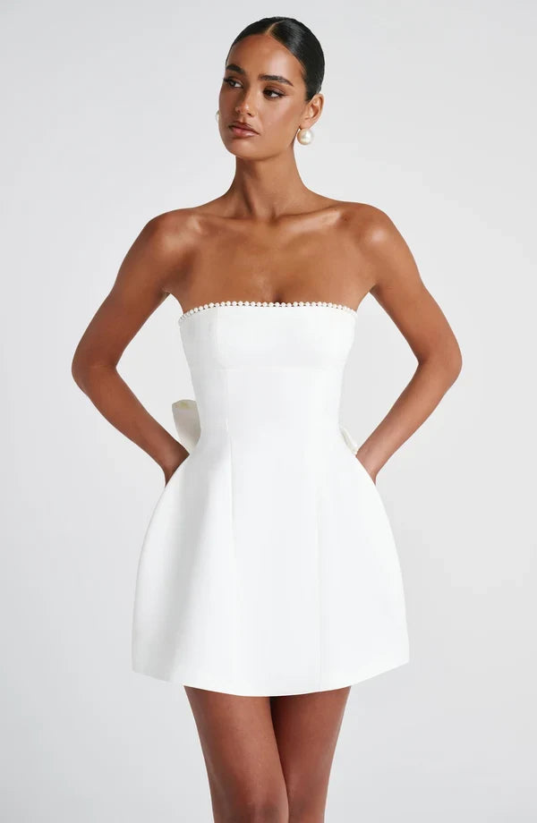 Strapless mini dress with pearl-trim neckline and oversized cascading back bow - view 16
