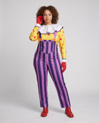 Women's clown Halloween costume with yellow polka dot top, white ruffle collar and purple striped overalls