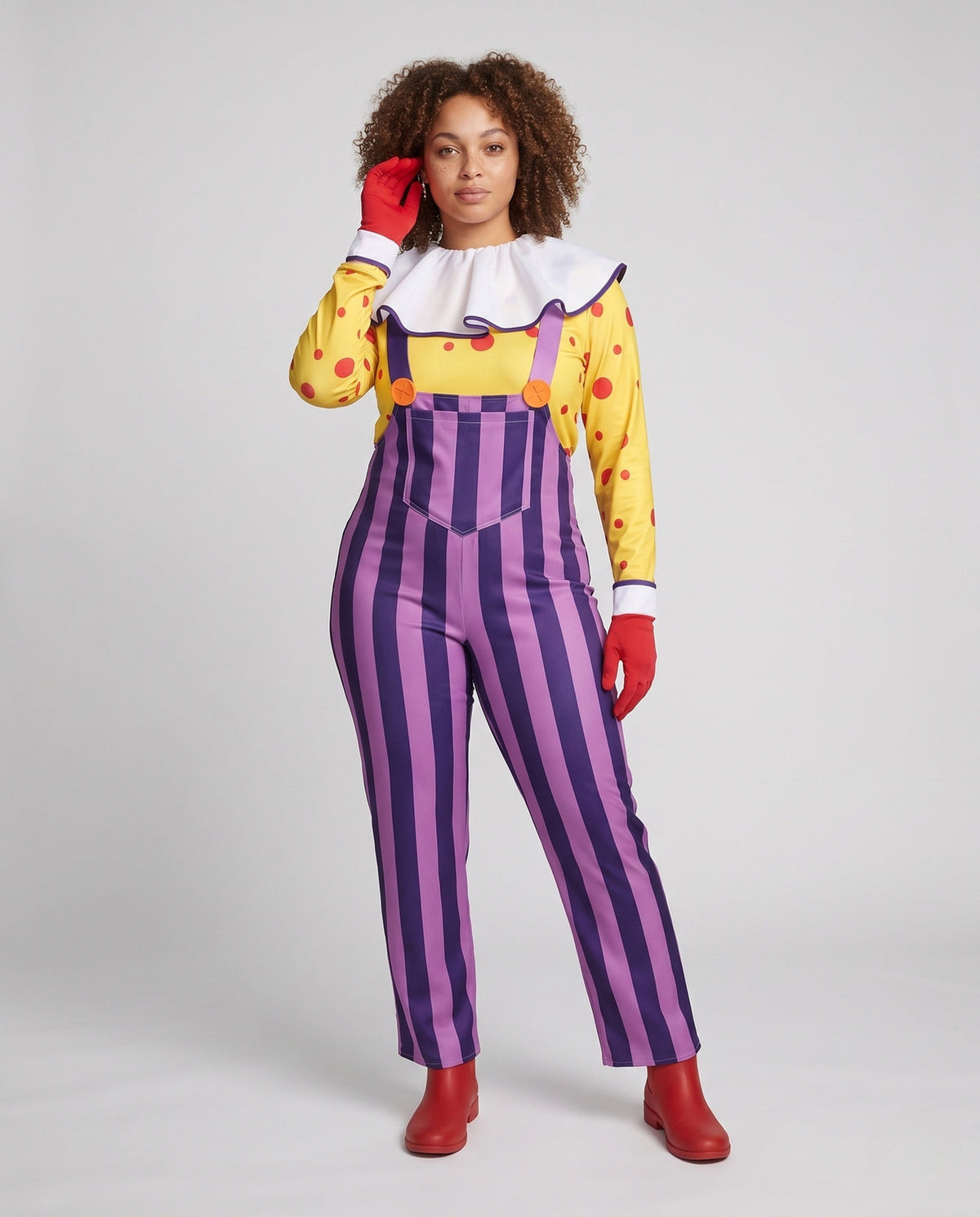 Women's clown Halloween costume with yellow polka dot top, white ruffle collar and purple striped overalls