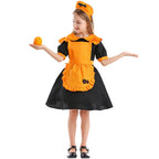 Girl wearing black puff-sleeve pumpkin Halloween costume dress with orange ruffled apron - view 3
