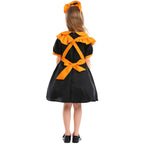 Girl wearing black puff-sleeve pumpkin Halloween costume dress with orange ruffled apron - view 5