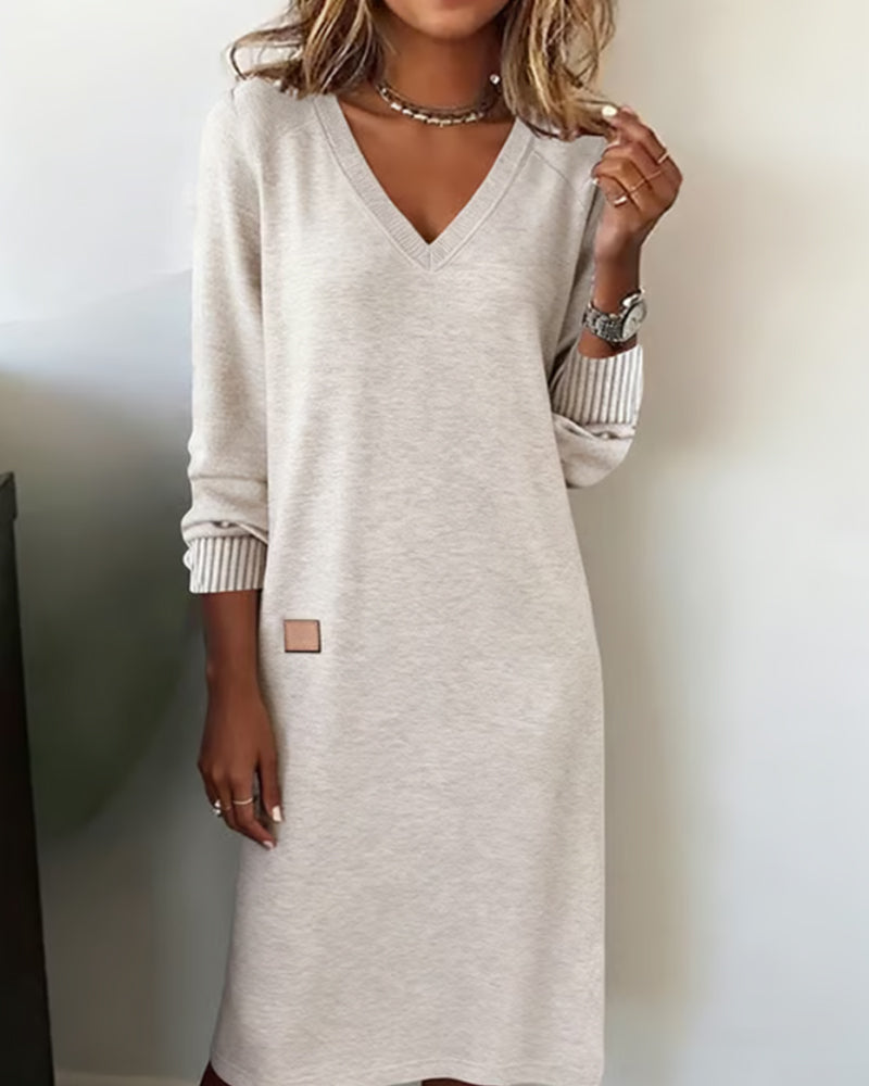 Woman wearing a relaxed V-neck midi sweater dress with raglan long sleeves and striped cuffs - view 4