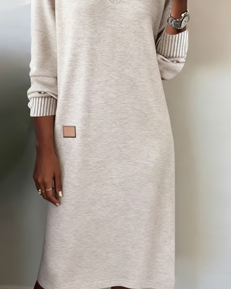 Woman wearing a relaxed V-neck midi sweater dress with raglan long sleeves and striped cuffs - view 6
