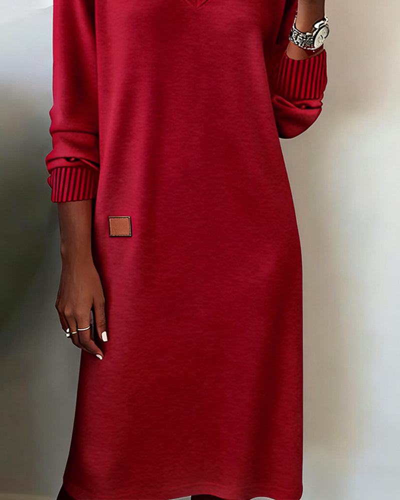 Woman wearing a relaxed V-neck midi sweater dress with raglan long sleeves and striped cuffs - view 9