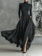 Black pleated maxi skirt set with fitted turtleneck top in motion