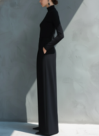 Woman in black long sleeve wide leg jumpsuit with turtleneck and pleated legs - view 6