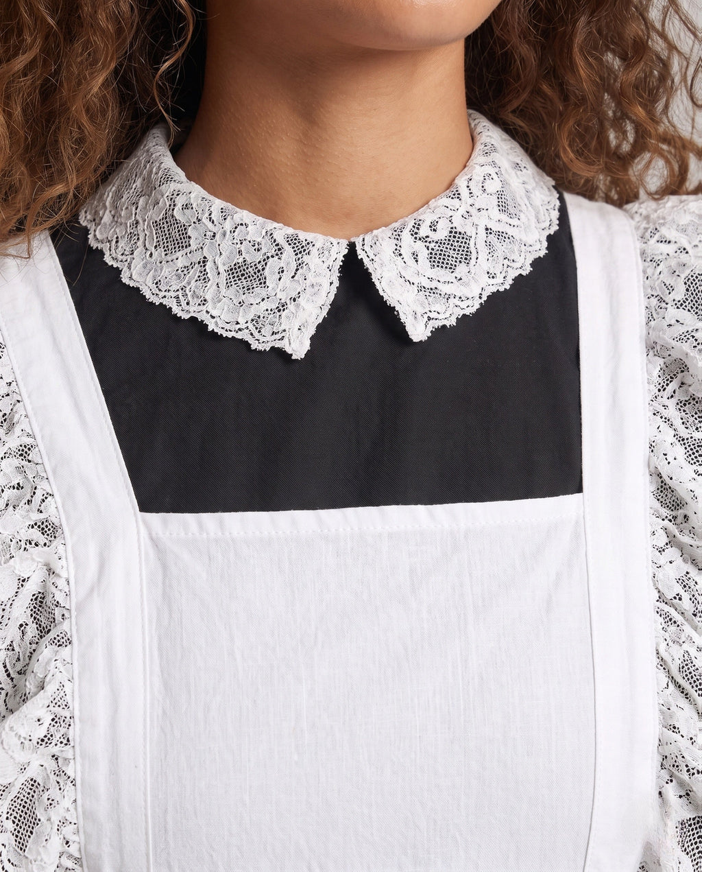 Women's black long sleeve maid Halloween costume with white lace-trimmed apron and lace collar - view 2