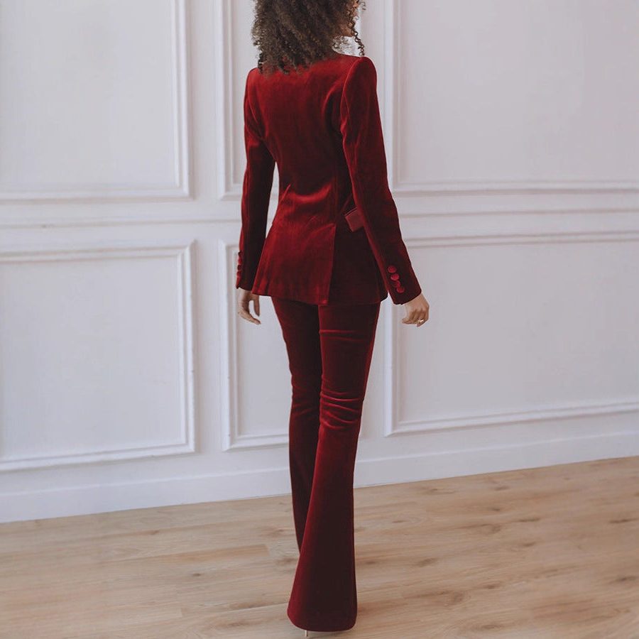 Woman wearing a red velvet suit with satin peak lapel blazer and flare pants - view 3