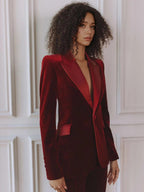 Woman wearing a red velvet suit with satin peak lapel blazer and flare pants - view 4
