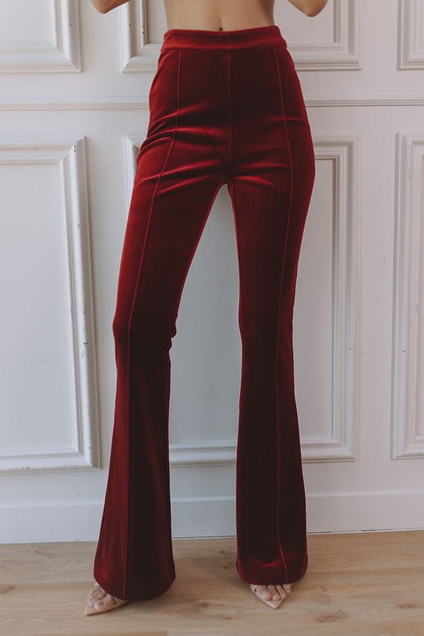 Woman wearing a red velvet suit with satin peak lapel blazer and flare pants - view 5