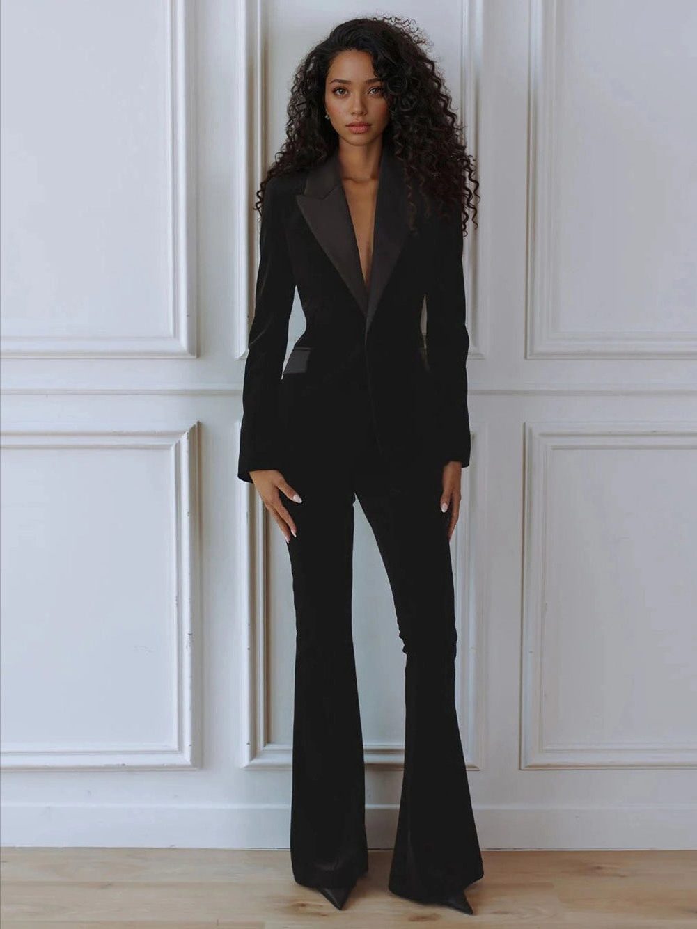 Woman wearing a red velvet suit with satin peak lapel blazer and flare pants - view 6