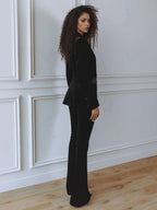 Woman wearing a red velvet suit with satin peak lapel blazer and flare pants - view 7