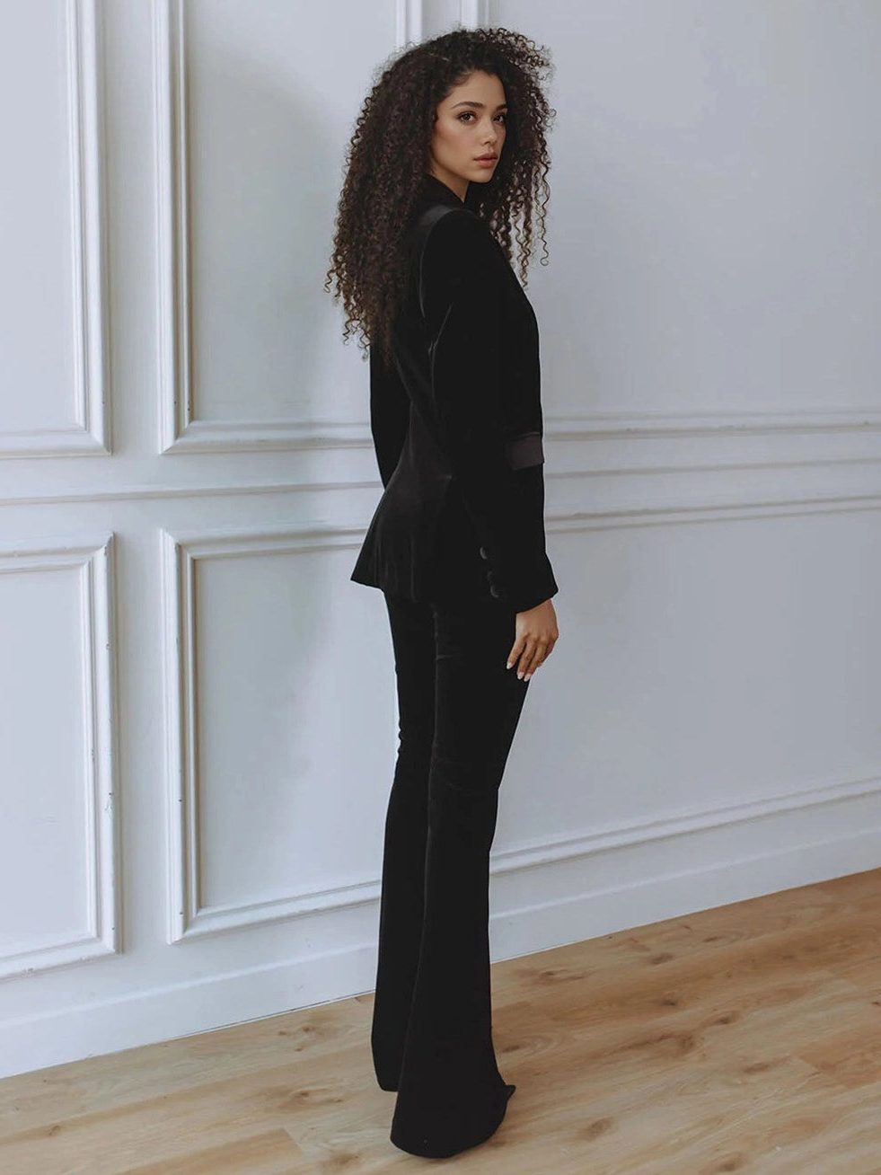 Woman wearing a red velvet suit with satin peak lapel blazer and flare pants - view 7
