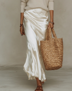 Woman wearing a satin slip dress with a ribbed V-neck sweater set - view 14