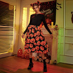 Black long sleeve midi dress with orange pumpkin print skirt