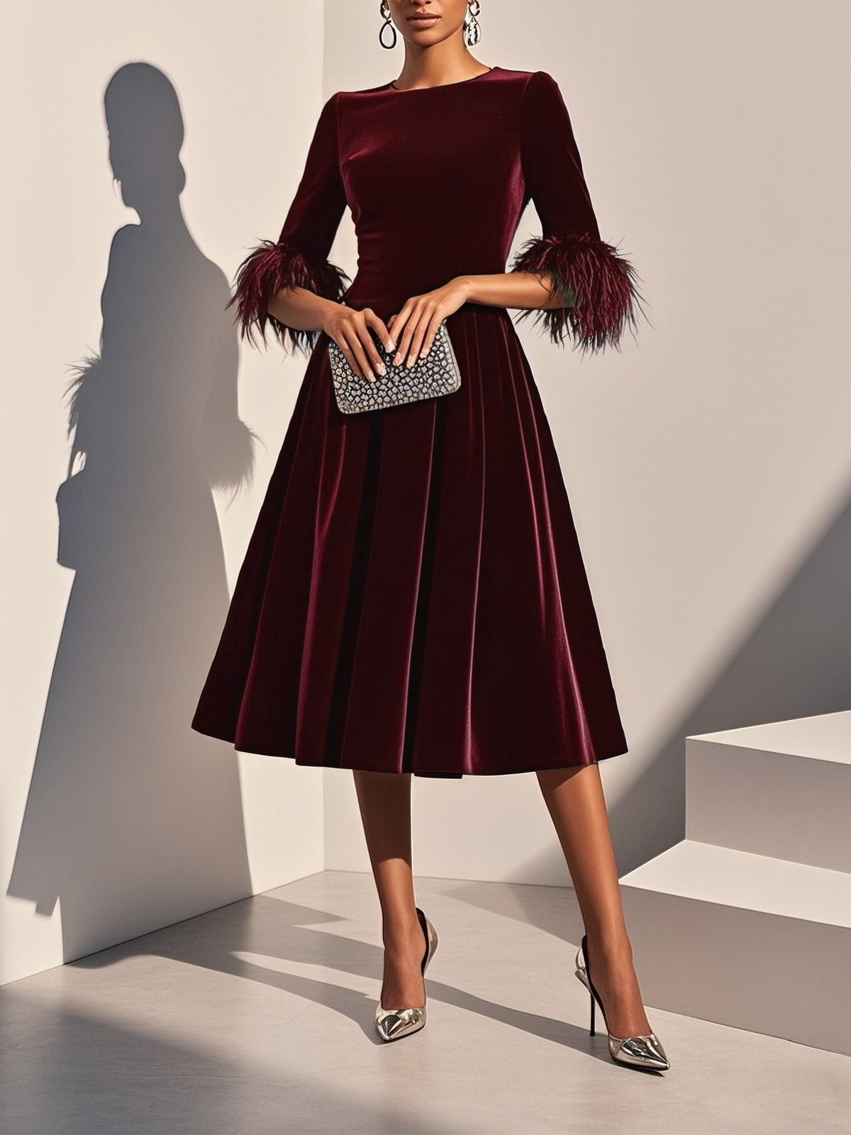 Burgundy velvet feather cocktail dress with A-line midi skirt and feather-trimmed cuffs