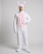 Man wearing a white plush bunny costume jumpsuit with pink belly panel and eared hood