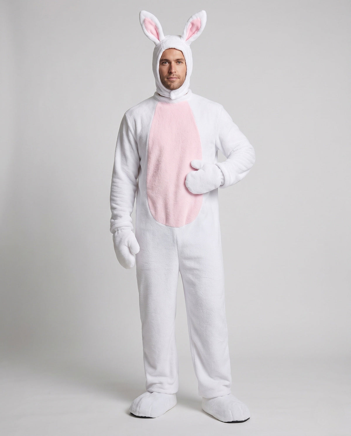 Man wearing a white plush bunny costume jumpsuit with pink belly panel and eared hood