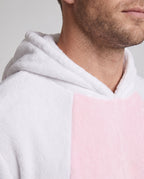Man wearing a white plush bunny costume jumpsuit with pink belly panel and eared hood - view 2