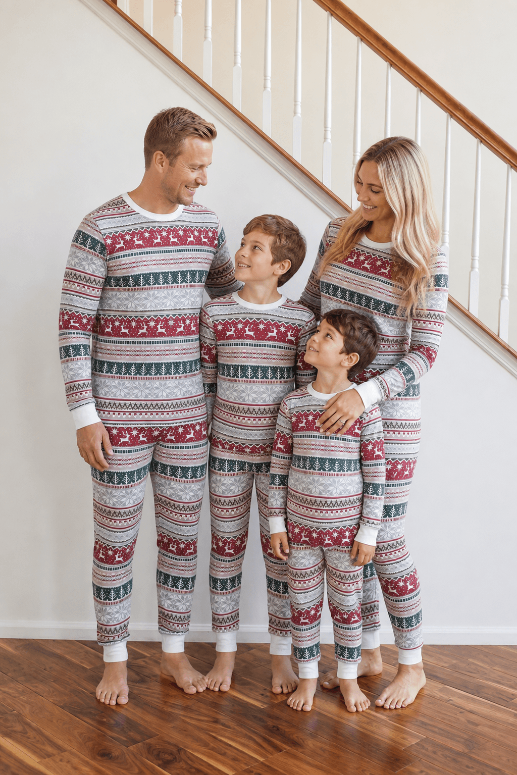 Family wearing matching gray Fair Isle Christmas pajamas with red reindeer and green tree stripes - view 3