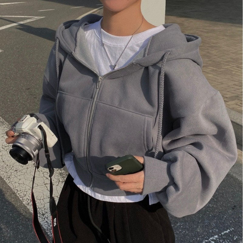 Cropped full zip hoodie with braided drawstrings on a woman