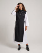 Women's nun Halloween costume with black hooded tabard over white long-sleeve robe