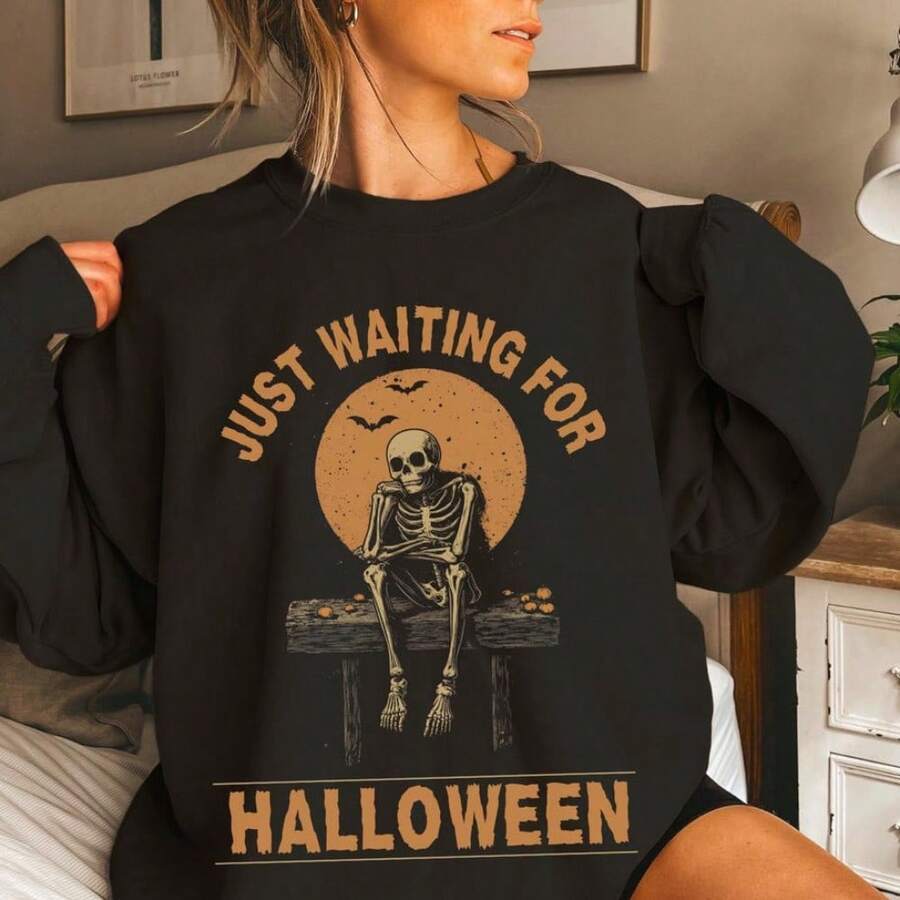 Black oversized crew neck sweatshirt with skeleton and Just Waiting for Halloween graphic