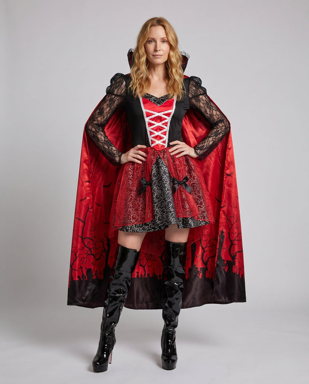 Women's vampire Halloween costume with lace sleeves and red graveyard-print cape