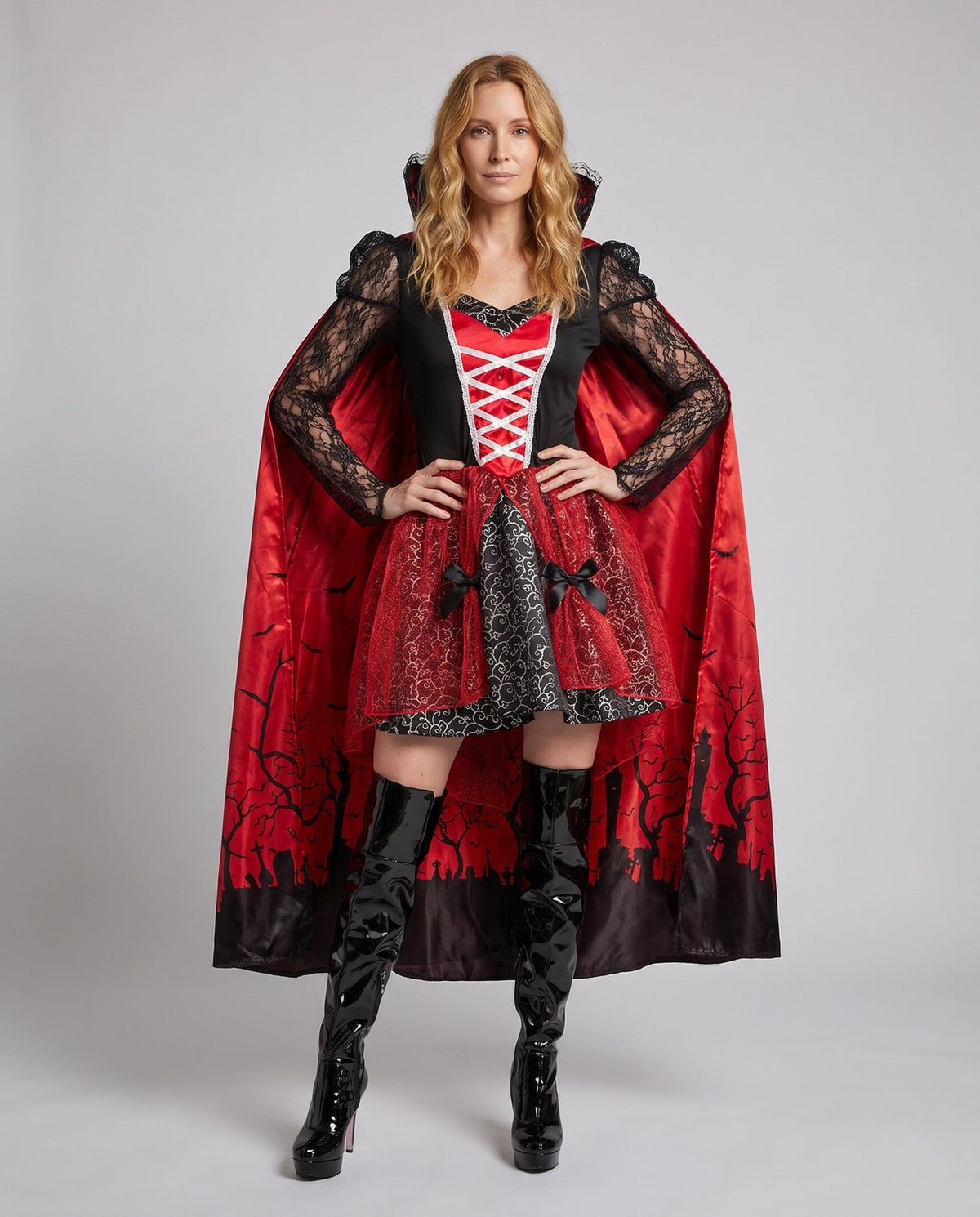 Women's vampire Halloween costume with lace sleeves and red graveyard-print cape