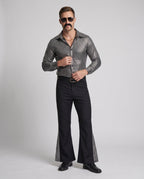 Men's disco costume with metallic silver square-print shirt and black flared pants