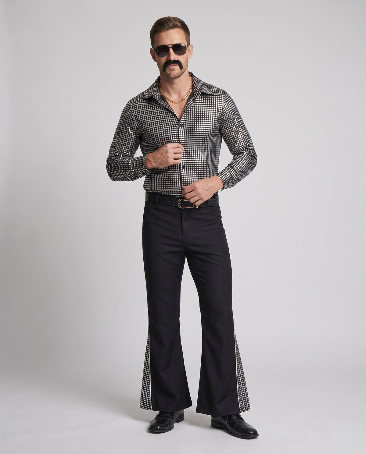 Men's disco costume with metallic silver square-print shirt and black flared pants
