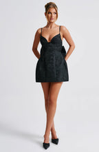 Black floral jacquard homecoming mini dress with plunging V neckline, lace-up back and oversized back bow - view 9