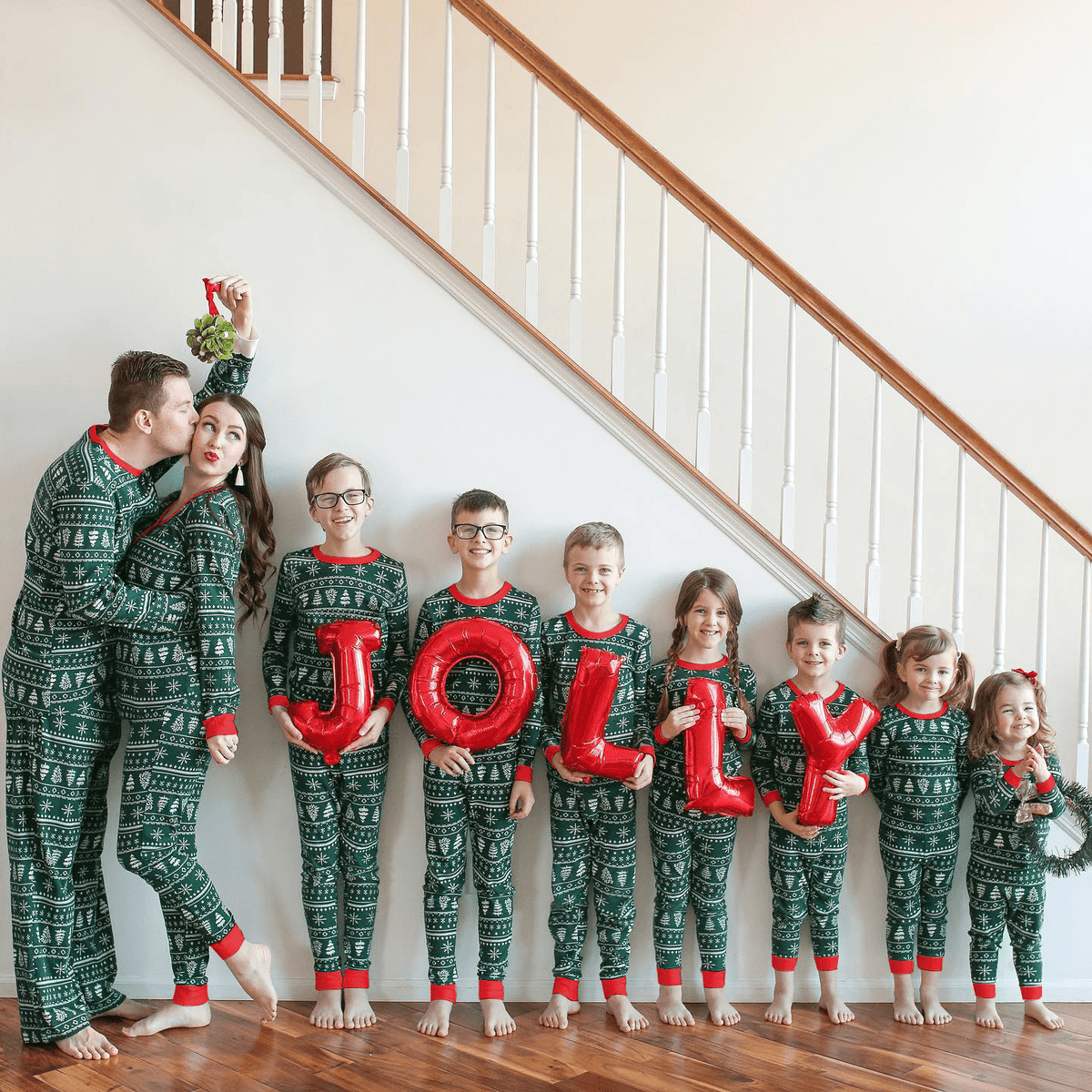 Matching family Christmas pajamas in green tree and snowflake print with red cuffs - view 14
