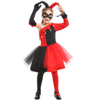 Girl wearing a red and black jester Halloween costume with one-shoulder bodice, pom-pom trim, tulle skirt and black eye mask