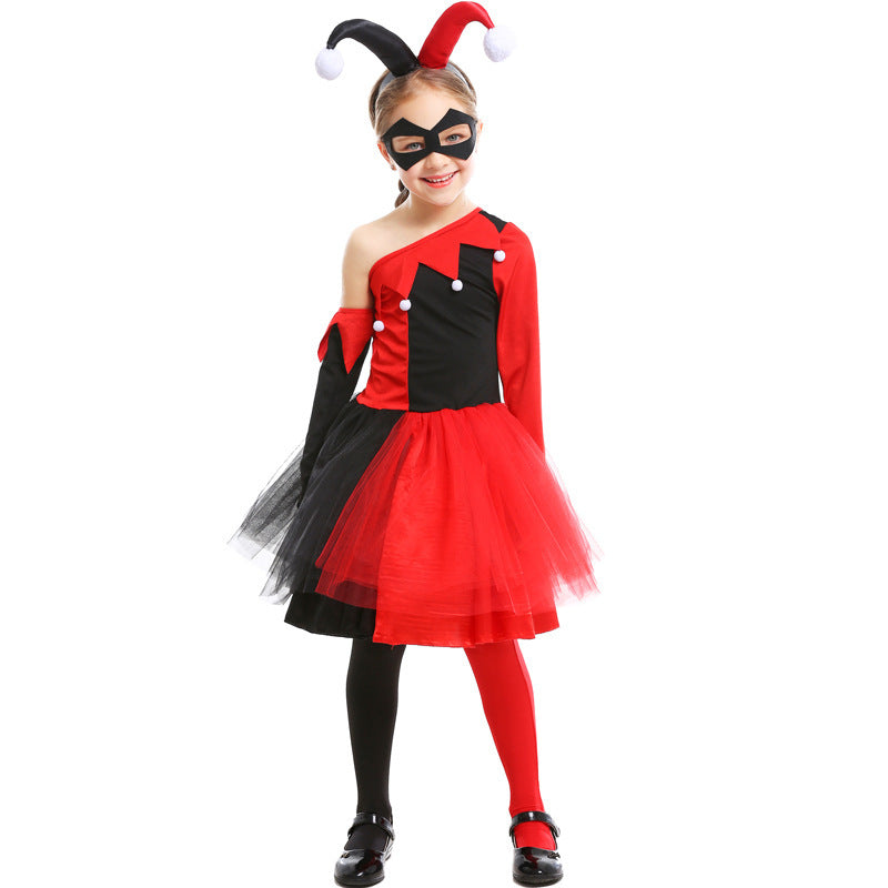 Girl wearing a red and black jester Halloween costume with one-shoulder bodice, pom-pom trim, tulle skirt and black eye mask - view 2