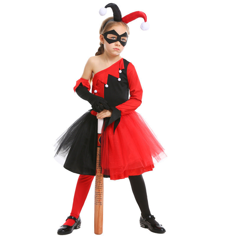 Girl wearing a red and black jester Halloween costume with one-shoulder bodice, pom-pom trim, tulle skirt and black eye mask - view 3