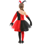 Girl wearing a red and black jester Halloween costume with one-shoulder bodice, pom-pom trim, tulle skirt and black eye mask - view 5